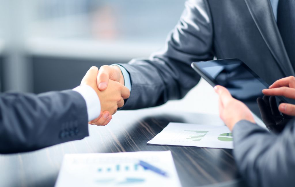 Business people shaking hands in office - KSDT • Accountants & Advisors