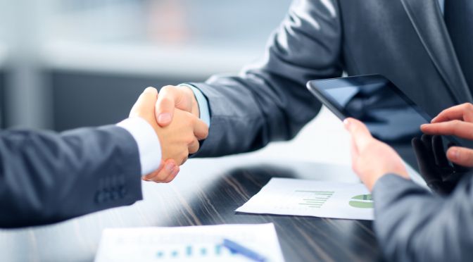 Business people shaking hands in office - KSDT • Accountants & Advisors