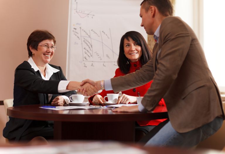 Business man and woman shaking hands - KSDT • Accountants & Advisors