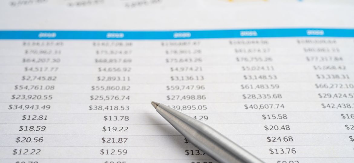 Pen on spreadsheet and graph paper Financial development Banki